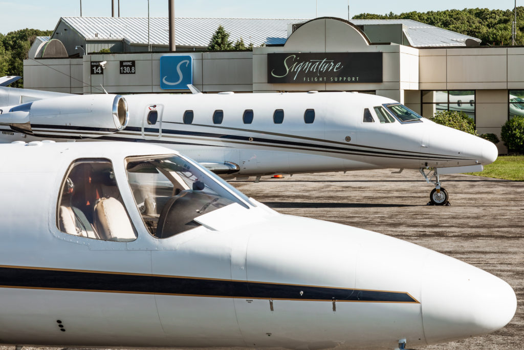 Two aircraft parked outside Signature FBO.
